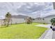 Spacious backyard with grassy lawn, playground, and patio at 14007 Creek Harbor Dr, Orlando, FL 32824