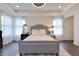 Main bedroom with gray upholstered bed and hardwood floors at 14007 Creek Harbor Dr, Orlando, FL 32824