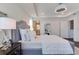 Bright bedroom with gray upholstered bed, and en-suite bathroom access at 14007 Creek Harbor Dr, Orlando, FL 32824