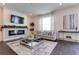 Bright living room with a fireplace, comfortable seating, and large windows at 14007 Creek Harbor Dr, Orlando, FL 32824