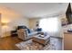 Cozy Gathering room featuring a sectional sofa, ottoman, and large window at 14007 Creek Harbor Dr, Orlando, FL 32824