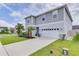 Two-story house with gray siding, white garage door, and landscaping at 14007 Creek Harbor Dr, Orlando, FL 32824