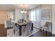 Bright dining room features a dark wood table with gray chairs and an area rug at 14007 Creek Harbor Dr, Orlando, FL 32824