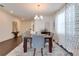 Elegant dining room with a wood table, gray chairs, and patterned curtains at 14007 Creek Harbor Dr, Orlando, FL 32824