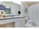 Bathroom with white vanity, toilet and polka dot shower curtain at 14007 Creek Harbor Dr, Orlando, FL 32824
