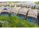 Aerial view of houses with pools and a lake at 8804 Macapa Dr, Kissimmee, FL 34747