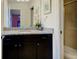Bathroom with single vanity, granite countertop, and shower at 8804 Macapa Dr, Kissimmee, FL 34747