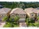 Luxury home with tile roof, two-car garage, and palm trees at 8804 Macapa Dr, Kissimmee, FL 34747