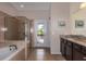Primary bathroom with garden tub, walk-in shower, and private access to pool at 8804 Macapa Dr, Kissimmee, FL 34747