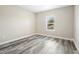 Simple bedroom with wood-look floors and a window at 1012 S Holly Ave, Sanford, FL 32771