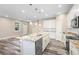 Modern kitchen with white cabinets, granite countertops, and wood-look floors at 1012 S Holly Ave, Sanford, FL 32771