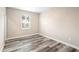 Simple bedroom with wood-look floors and a window at 1012 S Holly Ave, Sanford, FL 32771