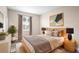 Light and airy bedroom with a light wood bed frame and neutral decor at 1012 S Holly Ave, Sanford, FL 32771