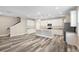 Modern kitchen with white cabinets, granite countertops, and wood-look floors at 1012 S Holly Ave, Sanford, FL 32771