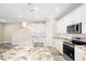 Modern kitchen with white cabinets, granite countertops, and wood-look floors at 1012 S Holly Ave, Sanford, FL 32771