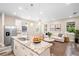 Open concept kitchen with white cabinets, granite island, and stainless steel appliances at 1012 S Holly Ave, Sanford, FL 32771