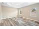 Spacious bedroom with wood-look floors and two windows at 1012 S Holly Ave, Sanford, FL 32771