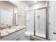 Bathroom with white cabinets, granite countertop, and a walk-in shower at 1012 S Holly Ave, Sanford, FL 32771