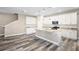 Modern kitchen with white cabinets, granite countertops, and wood-look floors at 1012 S Holly Ave, Sanford, FL 32771