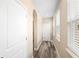 Bright hallway with neutral walls, wood-look flooring, and windows at 1012 S Holly Ave, Sanford, FL 32771