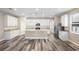 Open concept kitchen with island, stainless steel appliances, and white cabinets at 1012 S Holly Ave, Sanford, FL 32771