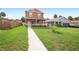 Two-story house with walkway, green grass, and a wooden fence at 1012 S Holly Ave, Sanford, FL 32771