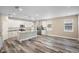 Modern kitchen with white cabinets, granite countertops, and wood-look floors at 1012 S Holly Ave, Sanford, FL 32771