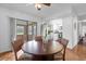 Bright dining area with wood flooring and a view into the kitchen at 354 Park Dr, Deland, FL 32724