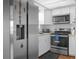 Modern kitchen with stainless steel appliances and white cabinets at 354 Park Dr, Deland, FL 32724