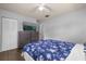 Bedroom with a large TV, dresser and floral bedspread at 354 Park Dr, Deland, FL 32724
