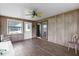 Sunroom with wood paneling, ceiling fan and sliding glass door at 354 Park Dr, Deland, FL 32724