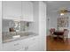 Kitchen boasts white cabinets and granite countertops at 354 Park Dr, Deland, FL 32724