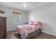Cozy bedroom with wood flooring and a window with natural light at 354 Park Dr, Deland, FL 32724