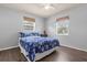 Bedroom with a blue floral bedspread and two windows at 354 Park Dr, Deland, FL 32724