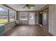 Sunroom with wood paneling, ceiling fan and sliding glass door at 354 Park Dr, Deland, FL 32724