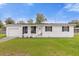 Single story home with a white exterior and attached garage at 354 Park Dr, Deland, FL 32724