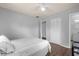 Bedroom with a grey and white bedspread and access to bathroom at 354 Park Dr, Deland, FL 32724
