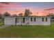 Single story home with a white exterior and attached garage at 354 Park Dr, Deland, FL 32724