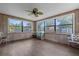 Sunroom with wood paneling, ceiling fan and sliding door at 354 Park Dr, Deland, FL 32724
