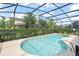 Inviting kidney-shaped pool with screened enclosure at 5229 Oakbourne Ave, Davenport, FL 33837