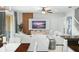 Spacious living room with sectional sofa, built-in media console, and large TV at 5229 Oakbourne Ave, Davenport, FL 33837