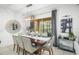 Elegant dining room with a large table, modern chandelier, and backyard access at 5229 Oakbourne Ave, Davenport, FL 33837