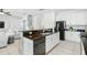 Modern kitchen boasts white cabinets, granite counters, and stainless steel appliances at 5229 Oakbourne Ave, Davenport, FL 33837