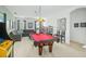 Fun game room with a pool table, arcade game, and comfortable seating at 5229 Oakbourne Ave, Davenport, FL 33837