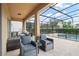 Relaxing screened-in patio with pool, seating, and dining area at 5229 Oakbourne Ave, Davenport, FL 33837