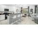 Modern kitchen with breakfast bar, white cabinets and black appliances at 5229 Oakbourne Ave, Davenport, FL 33837