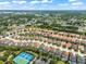 Aerial view of a residential neighborhood with tennis courts and lush greenery at 5229 Oakbourne Ave, Davenport, FL 33837