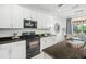 Modern kitchen with white cabinets, granite countertops, and a breakfast bar at 5229 Oakbourne Ave, Davenport, FL 33837