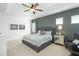 Main bedroom with king-size bed, seating area, and ceiling fan at 5229 Oakbourne Ave, Davenport, FL 33837
