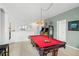 Game room features a pool table, arcade games, and ample space for entertainment at 5229 Oakbourne Ave, Davenport, FL 33837